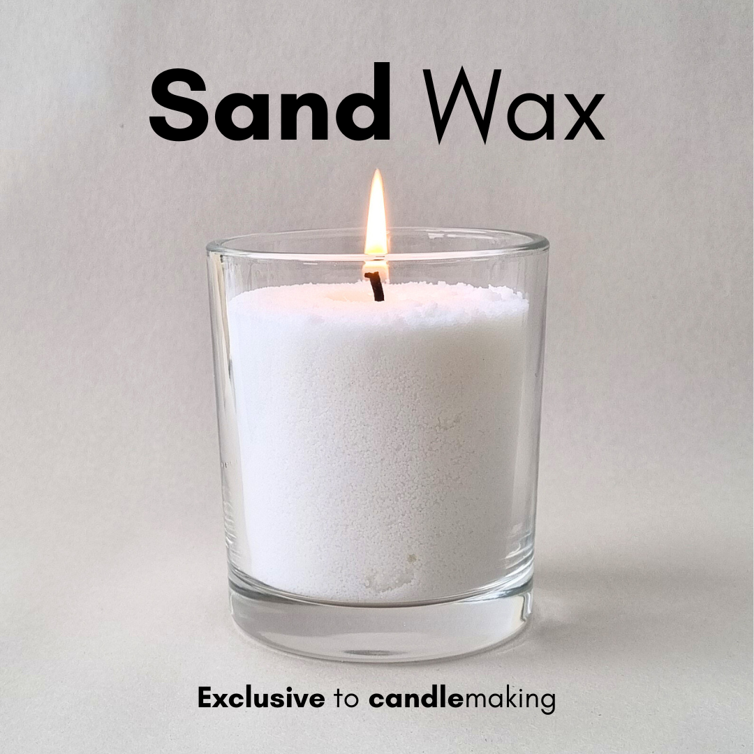 a lit candle made with sand wax
