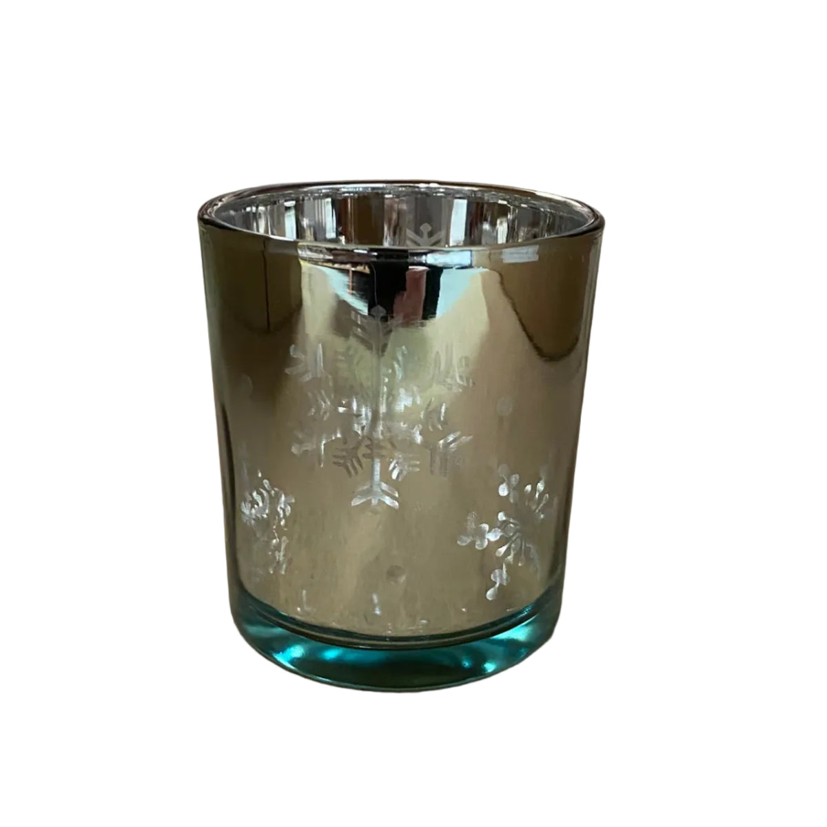 A small cylindrical glass candle holder with a reflective silver-toned finish and a blue-tinted base, photographed on a tabletop with a blurred warehouse or store background.