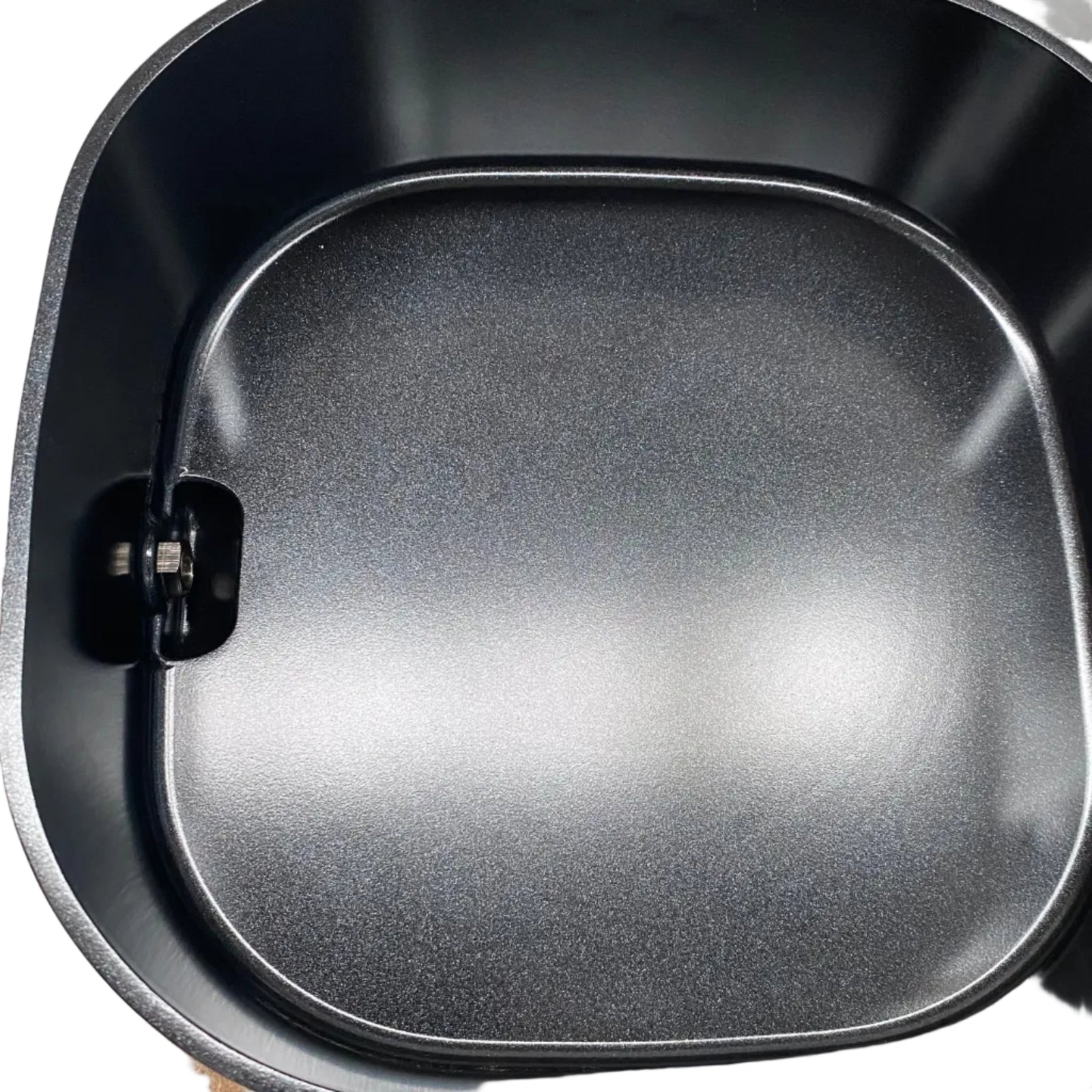 Top-down view of a black non-stick air wax melter, showing the interior coating and shape.