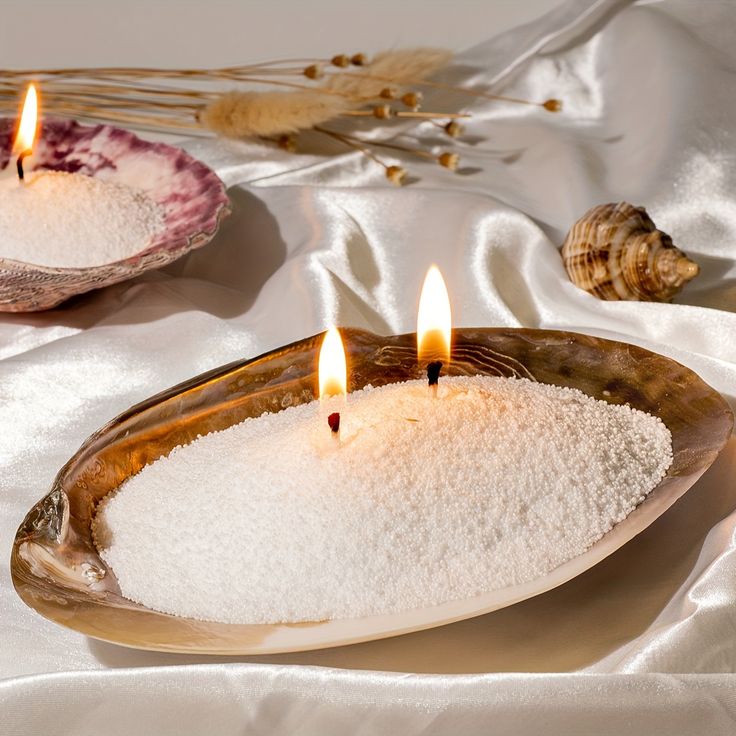 a lit shell candle made from sand wax
