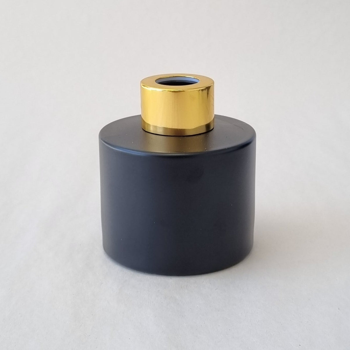 100ml round matte black diffuser bottle with gold lid